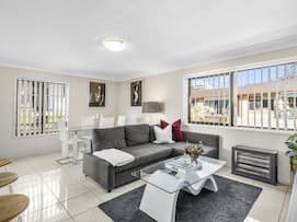 Living Room With Gray Couch — Seniors Real Estate in Gold Coast, QLD